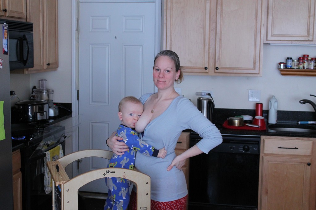 Abby Theuring, The Badass Breastfeeder's son breastfeeding on a learning tower.