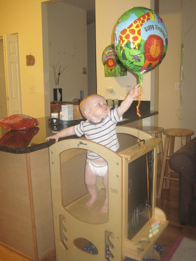 Abby Theuring, The Badass Breastfeeder's son on a learning tower.