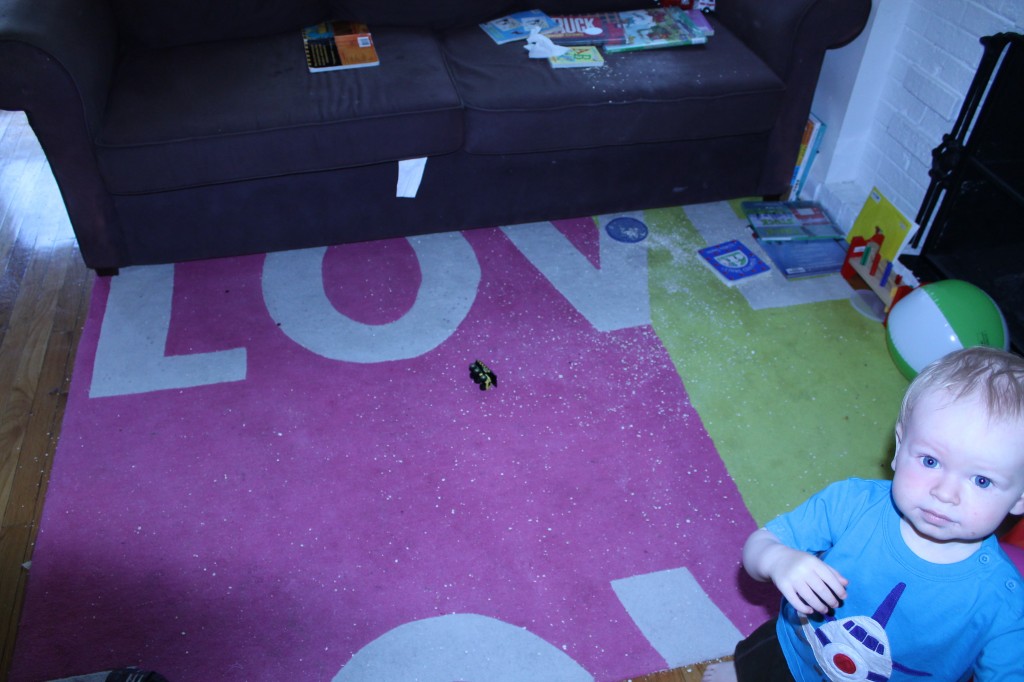 Abby Theuring, The Badass Breastfeeder's son on a dirty carpet. 