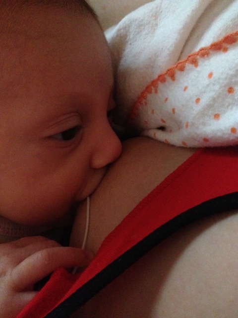 Jessica breastfeeding with a supplemental nursing system (SNS)