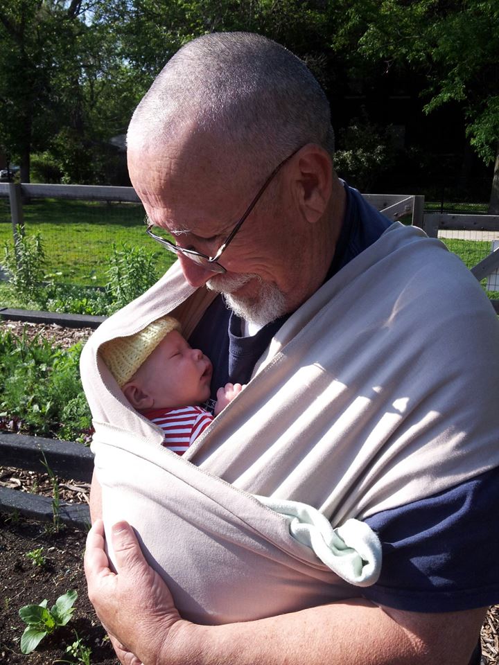 Grandfather wearing newborn