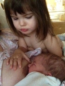 Cyndi breastfeeding while daughter watches 