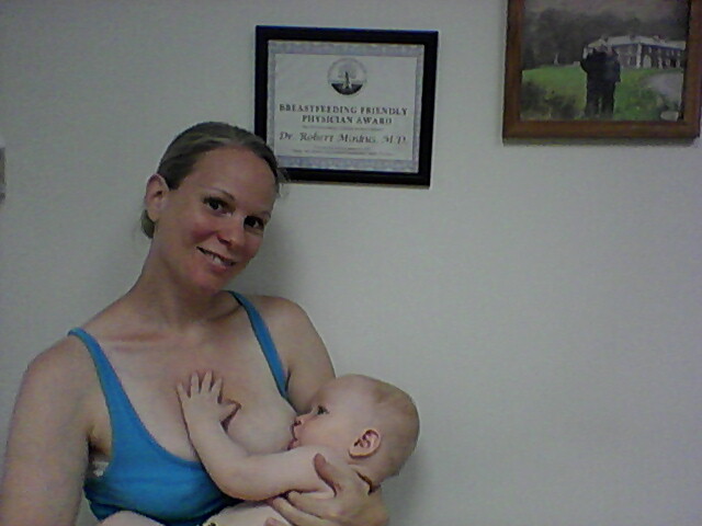 Abby Theuring, The Badass Breastfeeder breastfeeding her son. 